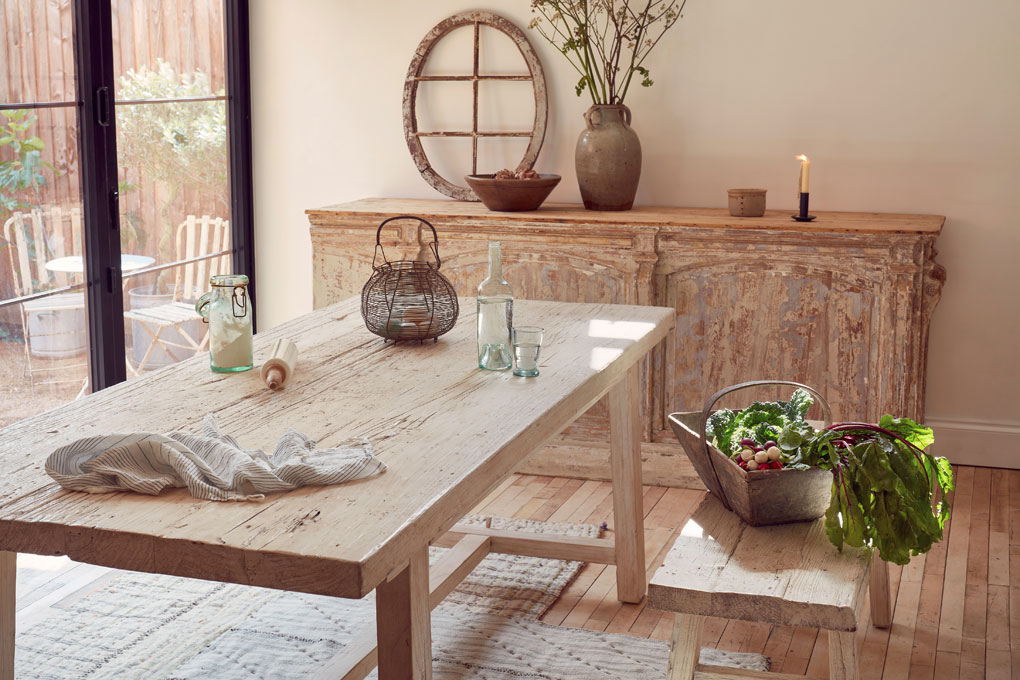 Home Barn’s rustic wooden dining table, bench and sideboard add texture to a neutral palette
