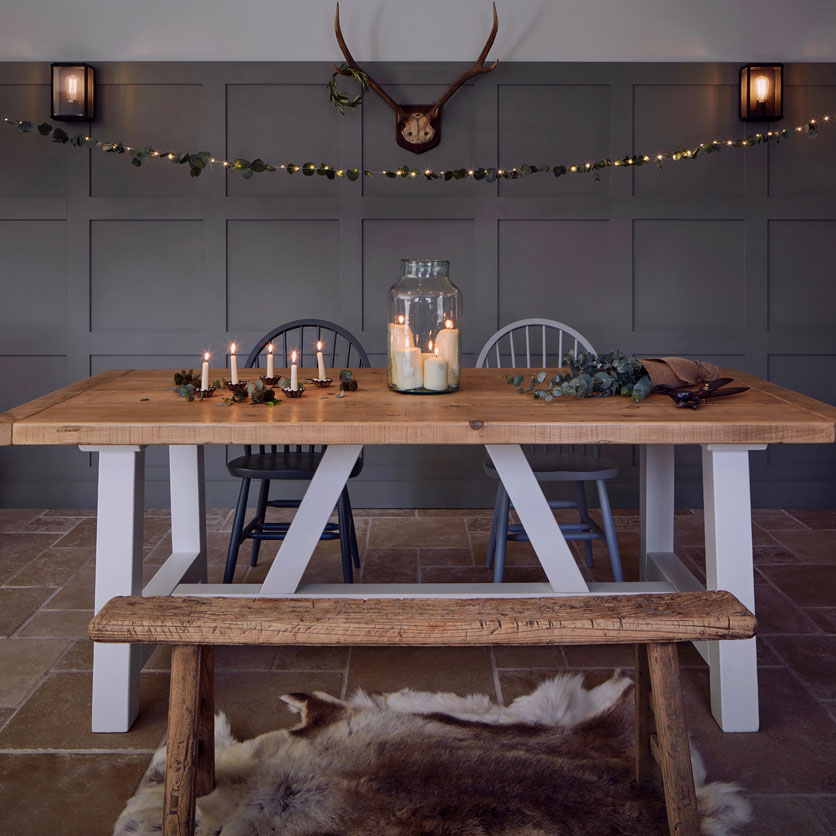 Rustic farm house table from Home Barn with bell jar filled with lots of candles and xmas decoration