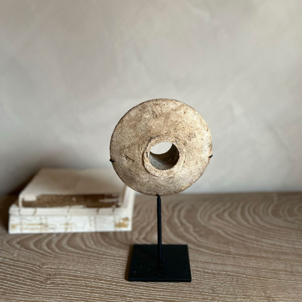 Antique stone disc on stand | A