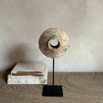 Antique stone disc on stand | B