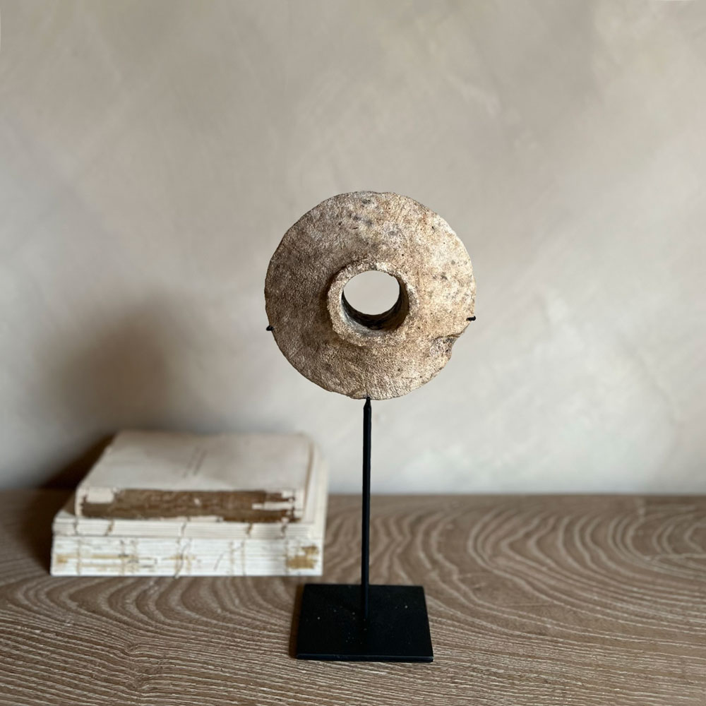 Antique stone disc on stand | B