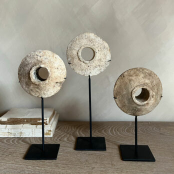 Antique stone disc on stand