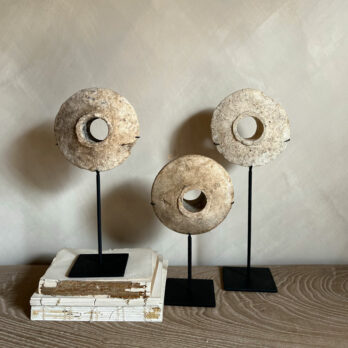 Antique stone disc on stand