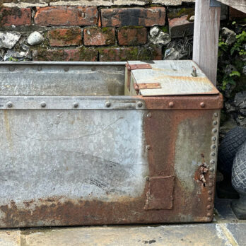 Antique riveted water trough planter
