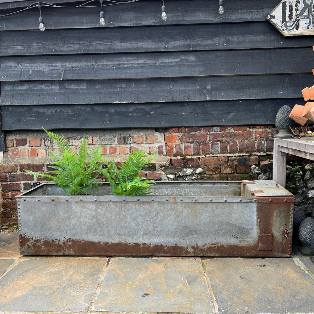 Antique riveted water trough planter
