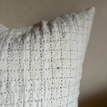 Black handstitched patchwork cushion