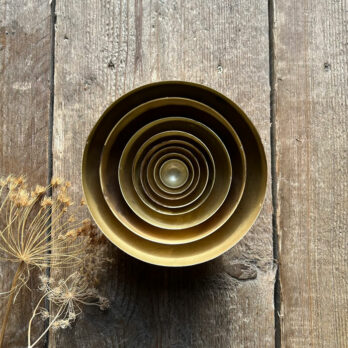 Set of eight gold metal bowls