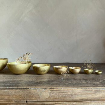 Set of eight gold metal bowls