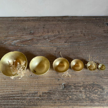 Set of eight gold metal bowls